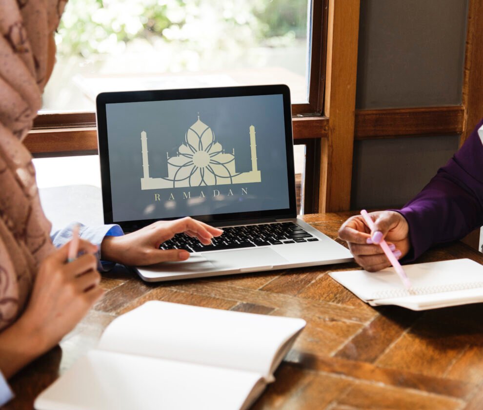 Islamic women discussing and using laptop for working