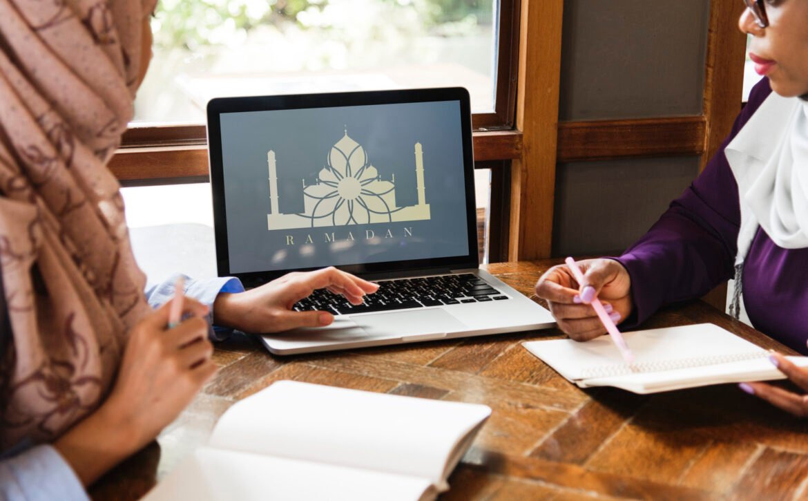 Islamic women discussing and using laptop for working